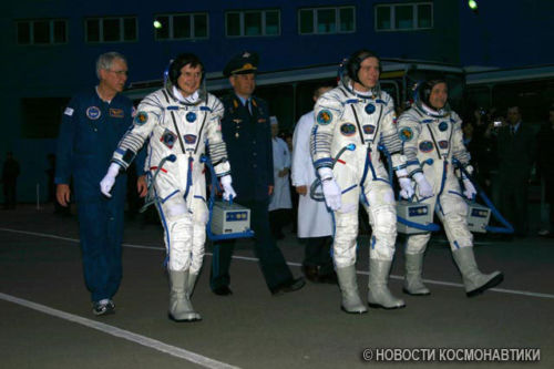 Cosmonauts wearing Sokol spacesuits and headsets.